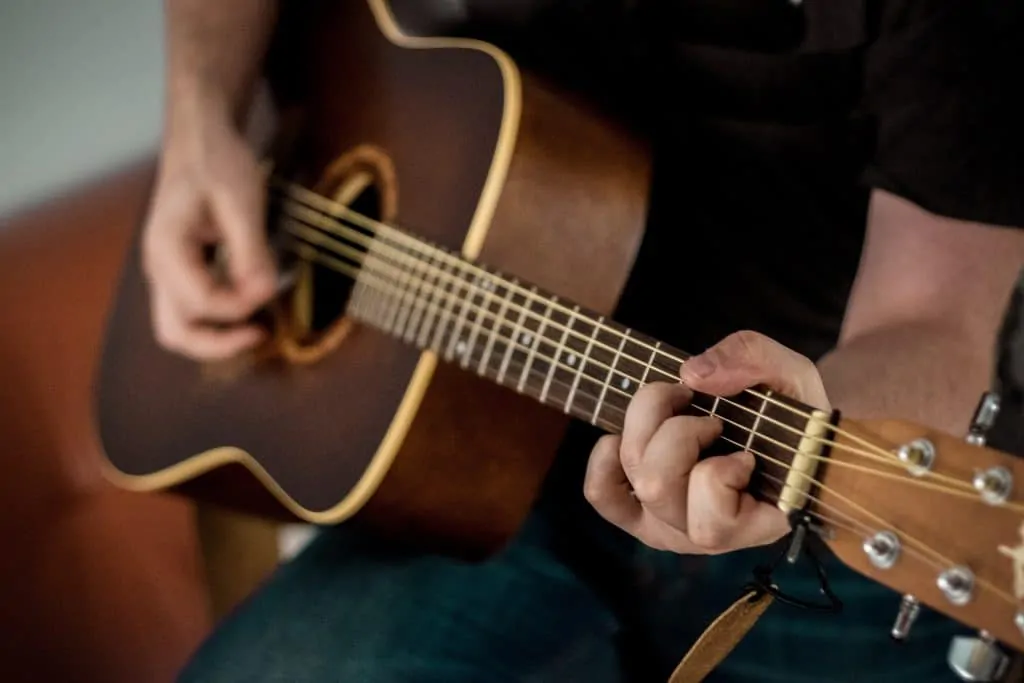 C shape on acoustic guitar Photo by 42 North on Unsplash