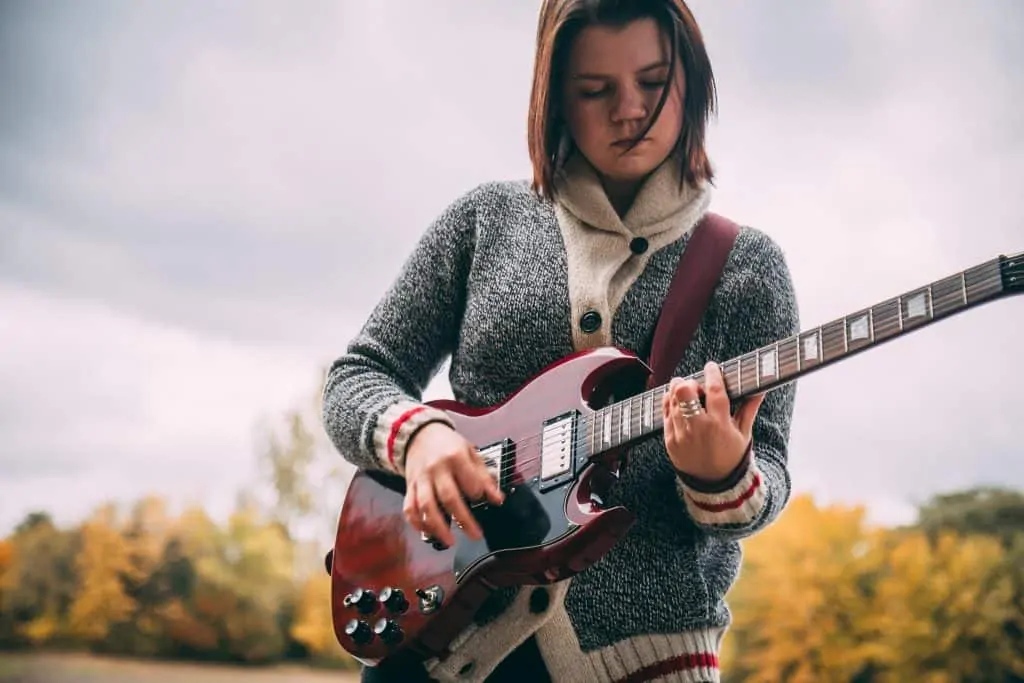 Woman playing SG guitar Photo by Alora Griffiths on Unsplash