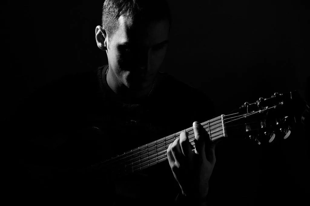 muscle memory guitarist in dark