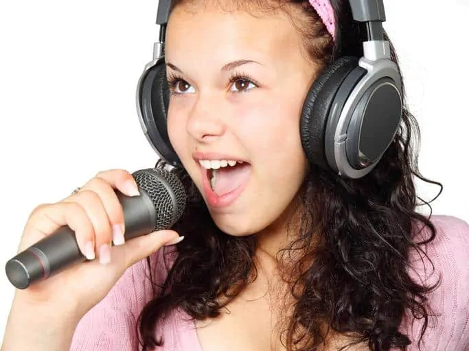 Tween Holding A karaoke Mic