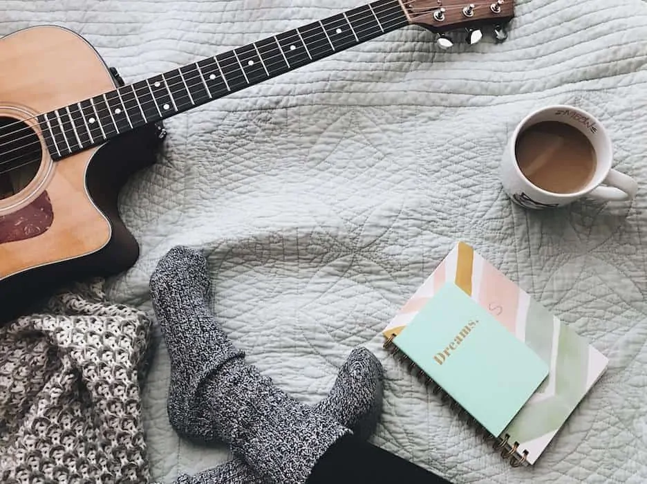 Guitar and journal on blanket