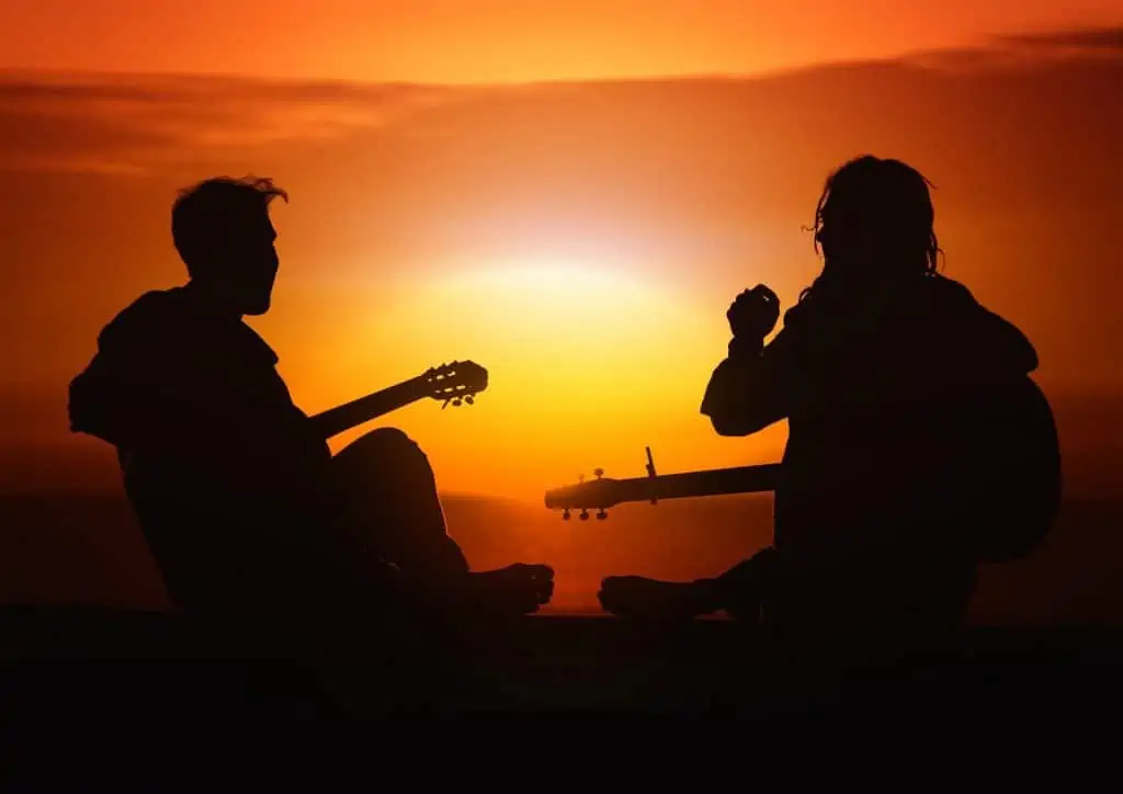 2. Two people playing guitar and singing